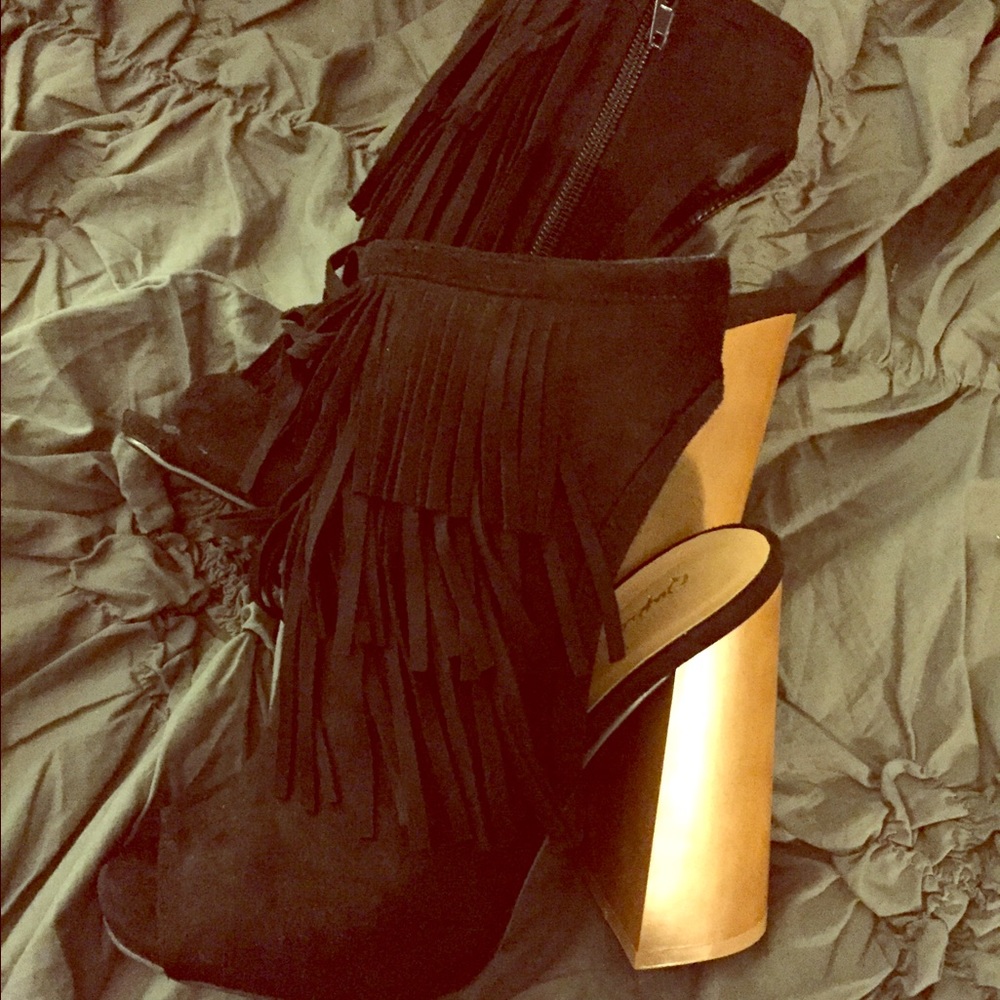 Black booties with fringe.
